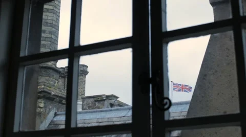 Looking at the Union Jack Flag out of a castle window. 動画素材 5658804