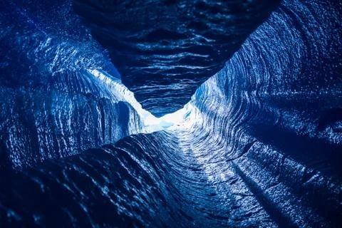 Looking up a vertical passage of a moulin deep inside a glacier in Alaska Stock Photos