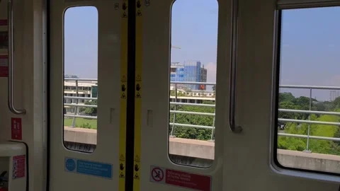 Looking at the view through the window of a moving LRT train Stock Footage 310092041