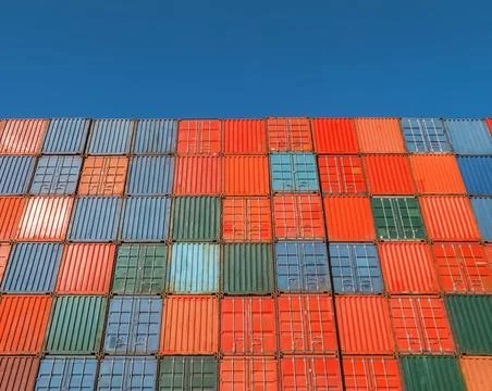 Looking up at a wall of cargo containers Stock Photos