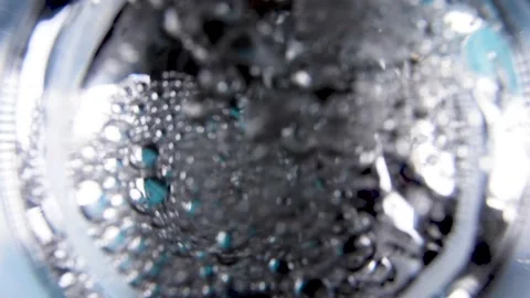 Looking on a water stream pouring into a transparent glass from a top Stock Footage 159483486