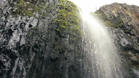 Looking up at a waterfall in slow motion Stock Footage 260572987