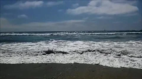 Looking at the waves on the beach Stock Footage 168118957