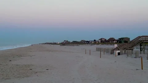 Looking west  down the beach at the light flashing on the Fire Island Lighthouse Stock Footage 254882584