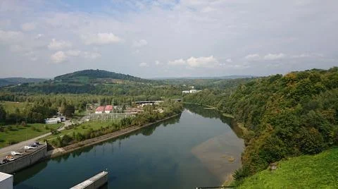Looking at the wide river flowing between the hills Stock Photos
