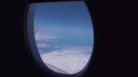 Looking the window of airplane with beautiful clouds sky Fotos de archivo