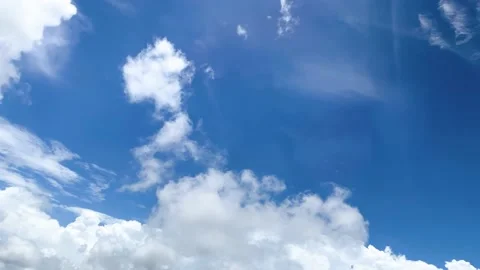 Looking from window passenger Airplane flying to white fluffy clouds on blue sky Video stock 218340000