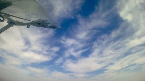 Looking at the wing and the sky while flying in a small plane - Video HD Stock Footage 106064135