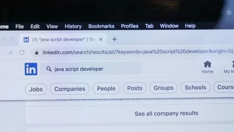Looking for wok at LinkedIn as Java Script developer on laptop at home Stock Footage 166119716
