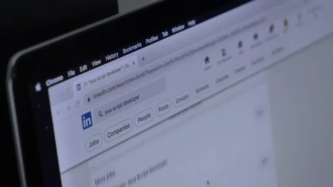 Looking for wok at LinkedIn as Java Script developer on laptop at home Stock Footage 166119754