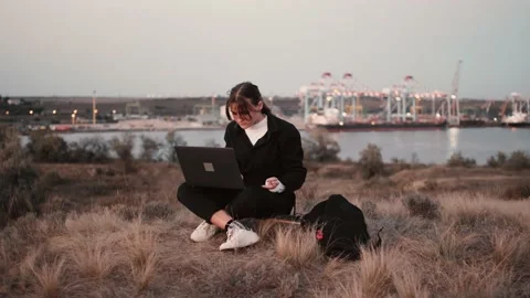Looking on young girl working note book, on the seaport background. Stock Footage 143558631