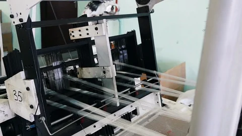 Loom creates fabric from needles and threads, slow shooting Stock Footage 103177169