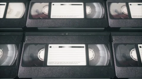 Loop Animation of VHS Cassettes Sliding Sideways in Retro Pattern Stock Footage 310959762