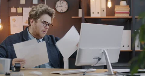 Loop of businessman looking at papers focused on reading documents working with 스톡 동영상 276352818