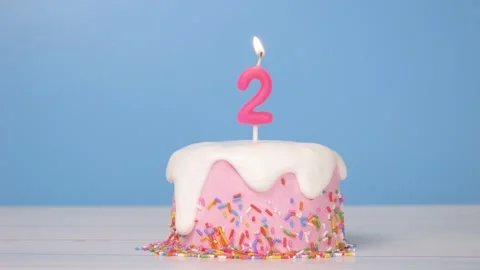 Loop of cute birthday cake with number two candle to celebrate 2nd birthday Stock-Footage 294521039