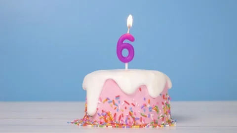 Loop of cute birthday cake with number six candle to celebrate 6th birthday Stock Footage 294521051