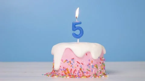 Loop of cute birthday cake with number five candle to celebrate 5th birthday Stock Footage 294521059