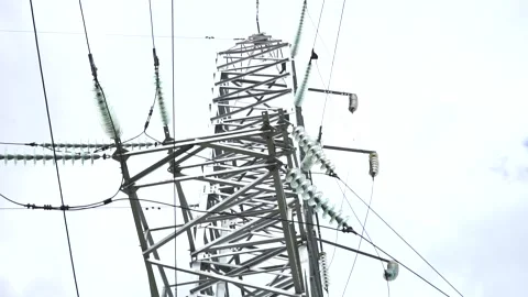Loop of of an electricity pylon shot from a low angle, Video stock 137260017