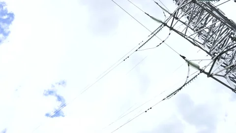 Loop of of an electricity pylon shot from a low angle, Video stock 137260281