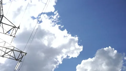 Loop of of an electricity pylon shot from a low angle, Video stock 137260582