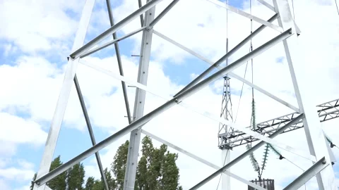 Loop of of an electricity pylon shot from a low angle, Video stock 137260726