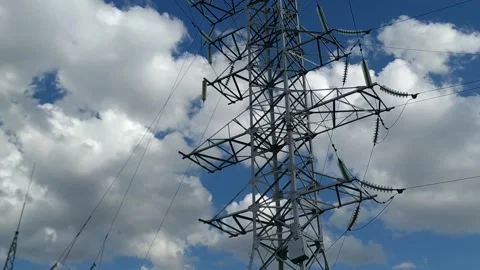 Loop of of an electricity pylon shot from a low angle, Video stock 137388195