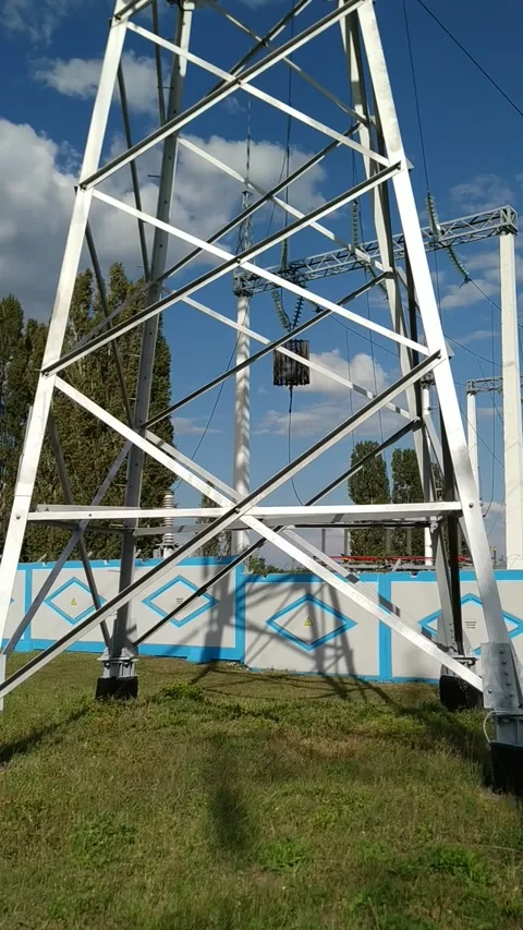 Loop of of an electricity pylon shot from a low angle, Video stock 137388349