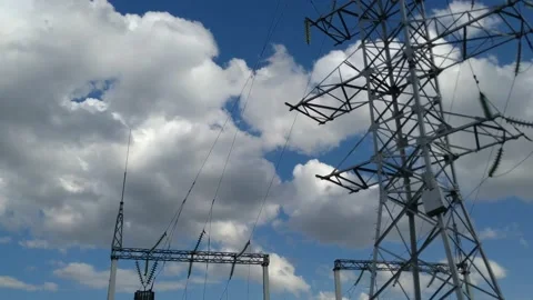 Loop of of an electricity pylon shot from a low angle, Video stock 137388403
