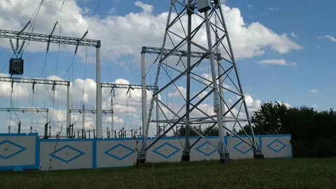 Loop of of an electricity pylon shot from a low angle, Video stock 137388440