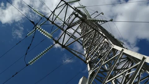 Loop of of an electricity pylon shot from a low angle, Video stock 137388486
