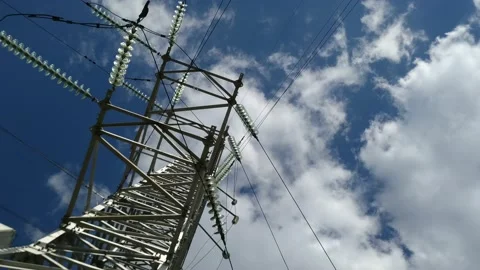 Loop of of an electricity pylon shot from a low angle, Video stock 137388526