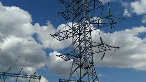 Loop of of an electricity pylon shot from a low angle, Video stock 137388574