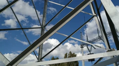 Loop of of an electricity pylon shot from a low angle, Video stock 137388650