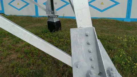 Loop of of an electricity pylon shot from a low angle, Video stock 137388687