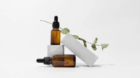 Loop of glass bottles with eucalyptus on concrete pedestal stop motion animation Stock Footage 152018321