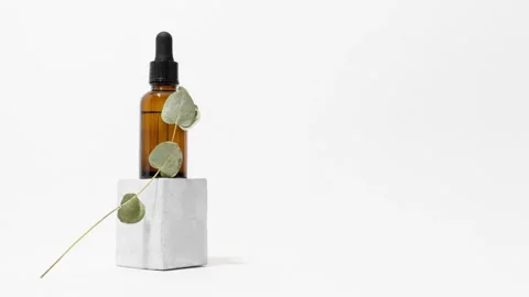 Loop of glass pipette bottle with eucalyptus on pedestal stop motion animation Stock Footage 152018323