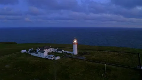 Loop Head Lighthouse Aerial Orbit, Glowing Above the Atlantic Ocean Stock Footage 291554261