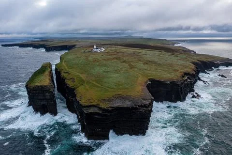 Loop Head Lighthouse and cliffs on a stormy evening Stock Photos