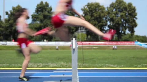 Loop hurdle female runners Stock Footage 26184389