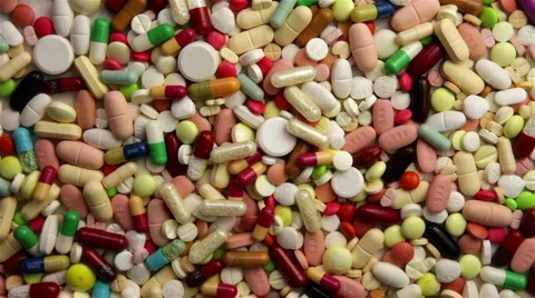 Loop of many pills spinning Stock Footage 6762531