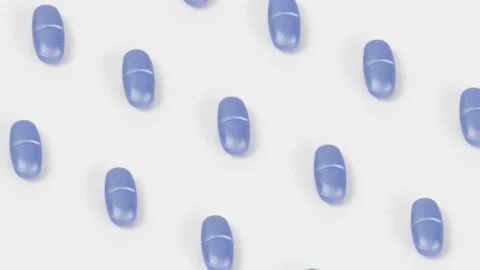 Loop pattern 4k blue pills rotate on a white background Isolated Motion loop Stock Footage 231569020