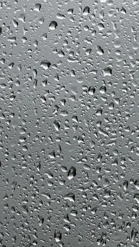 Loop raindrops flows on wet glass vertical window Stock Footage 345683490