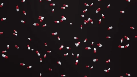 Loop of Red and White Pills Falling on a Black Background Stock Footage 72420053