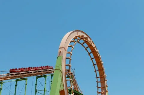 A loop of a scary roller coaster on blue sky background with copy space. Stock Photos