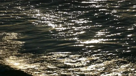 Loop of the sea waves. Backlight with patches of sunlight. Natural dawn footage. Stock Footage 68050745