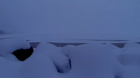 Loop: Snow blowing in from lake, slow motion Stock Footage 20829408
