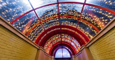 Loop video on festively lit underground passage tunnel with red frame arch Stock Footage 282652934