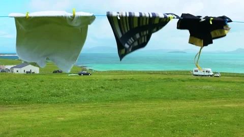 LOOP, Wind Dries Towels and a Swimming Trunk on Airer, Cloudy Day, Slow Motion Stock Footage 156311672