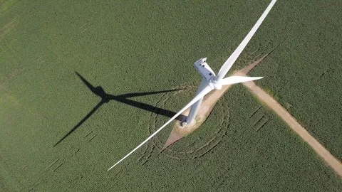 Loopable aerial video of wind turbine turning over corn field in Minnesota. Stock Footage 113005998