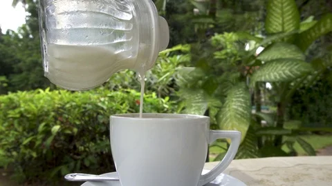 Loopable Cinemagraph of Adding Milk into Cup of Coffee Stock Footage 103322897